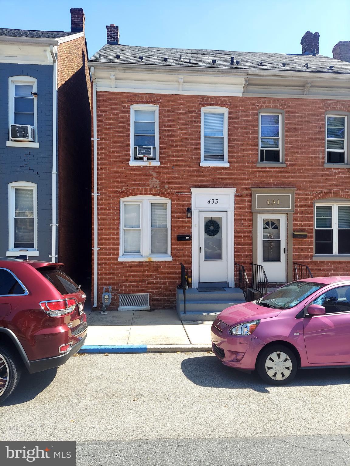 a front view of a house with a parking space