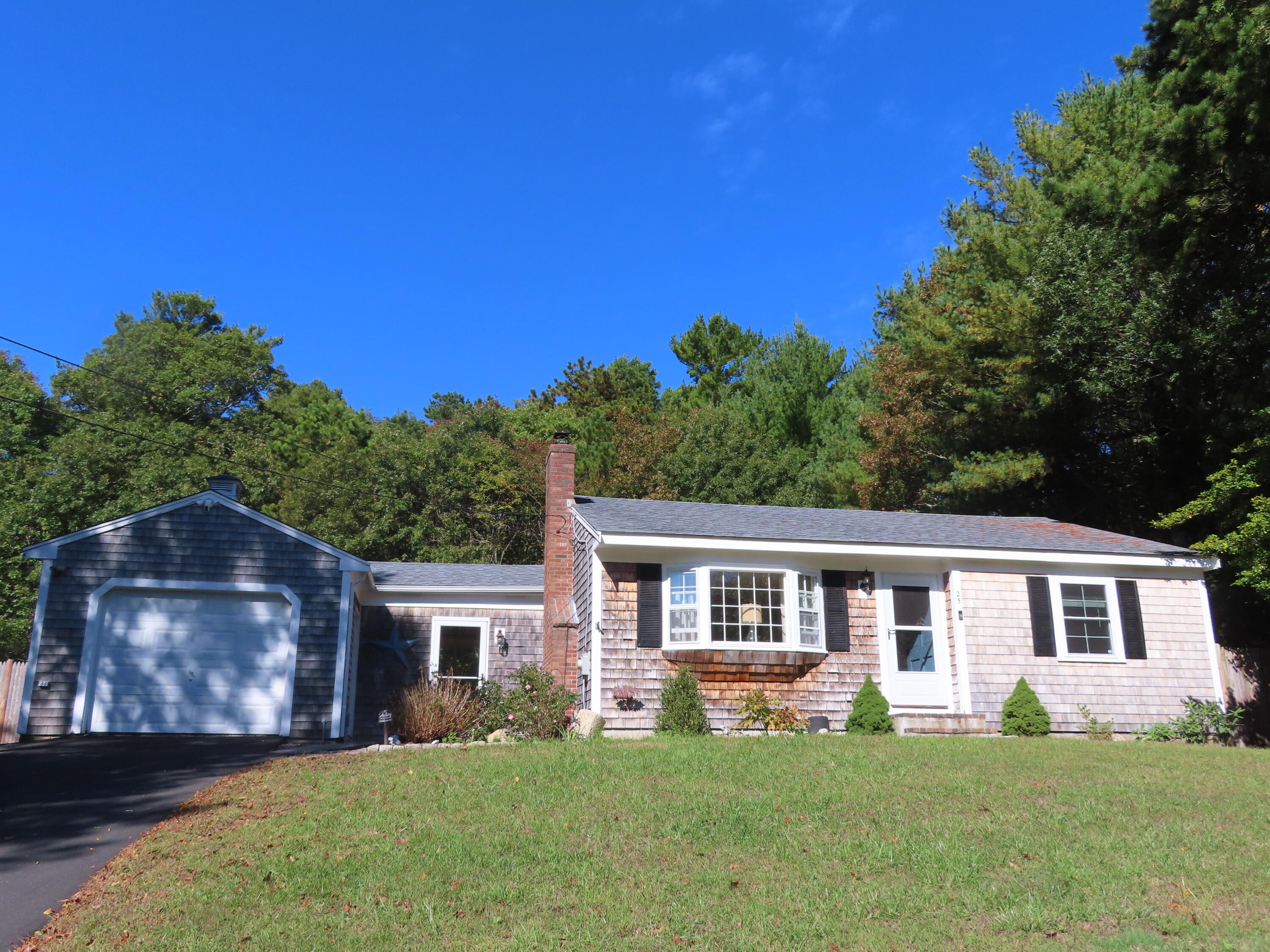 a front view of house with yard and green space