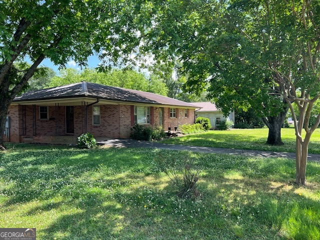 a front view of house with yard and green space