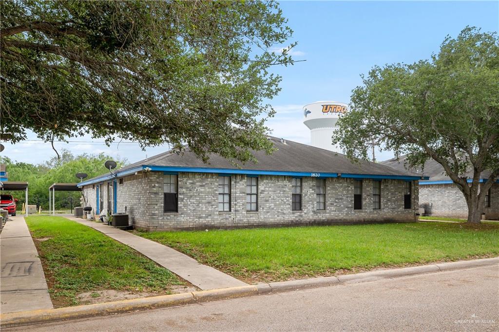 a view of house with a yard