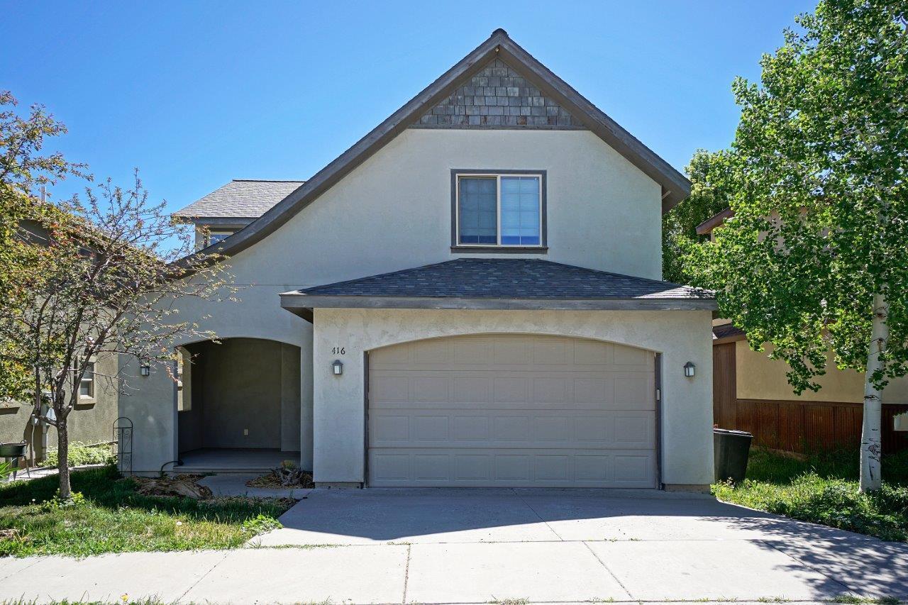 a front view of a house with a garage