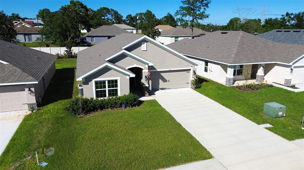 a aerial view of a house with yard and green space