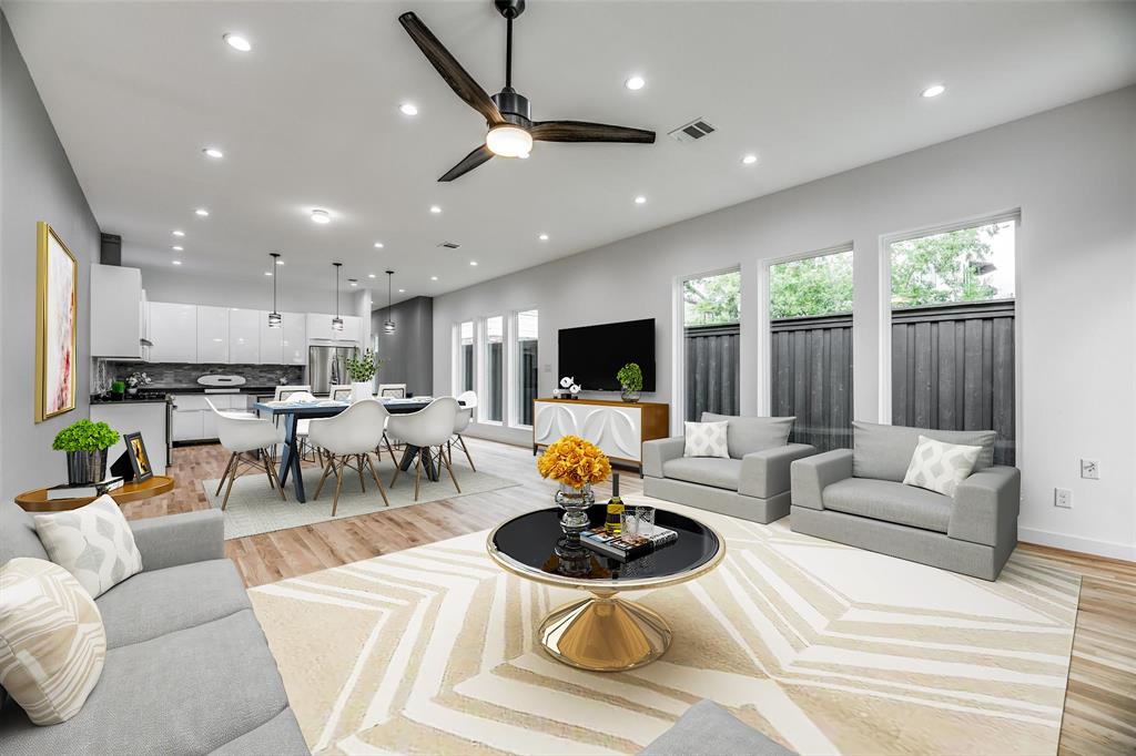 Living room with light hardwood / wood-style flooring and ceiling fan