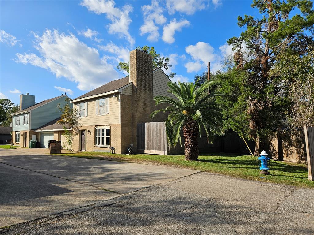 a front view of a house with a yard and trees