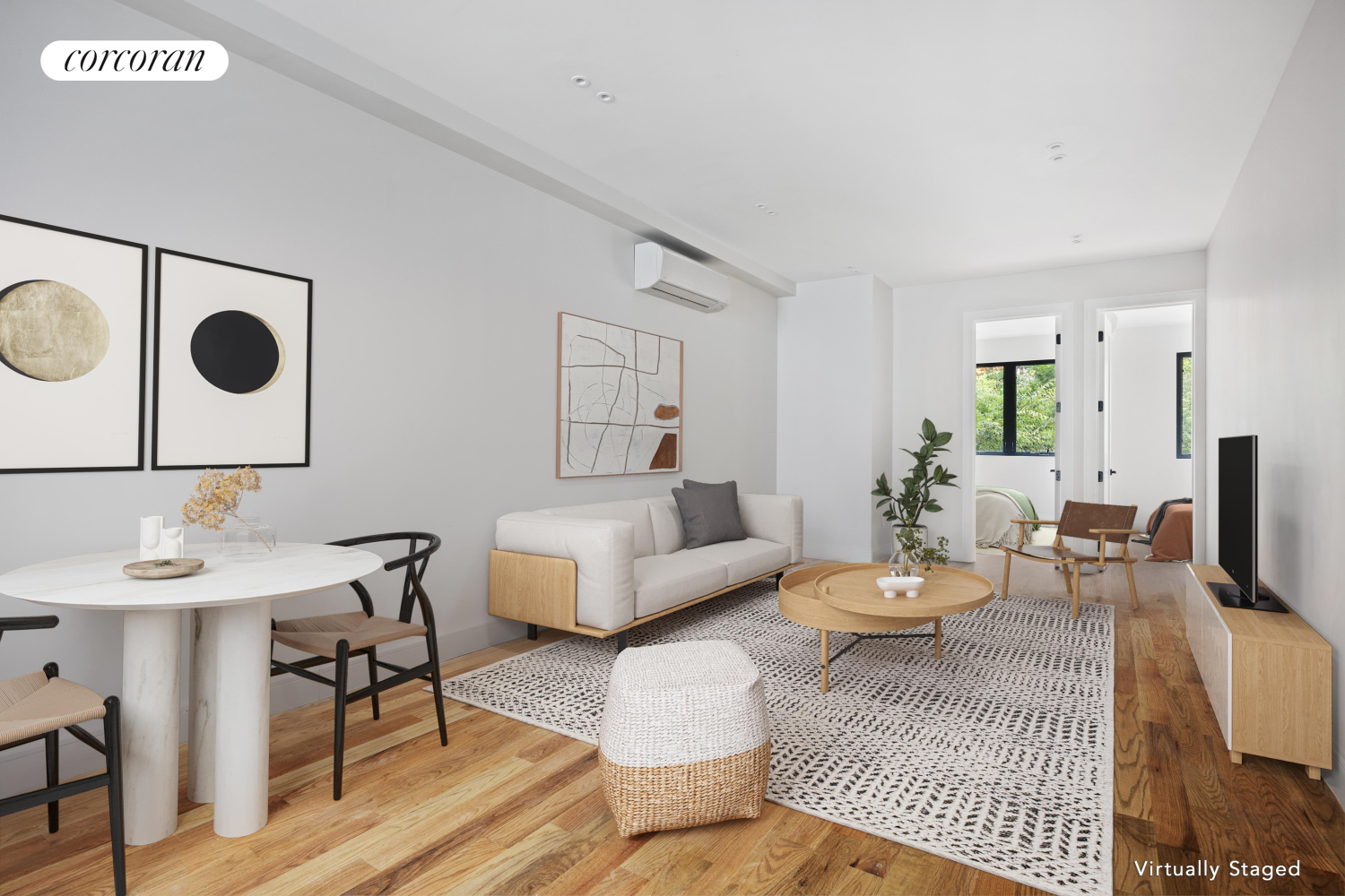 a living room with furniture and wooden floor