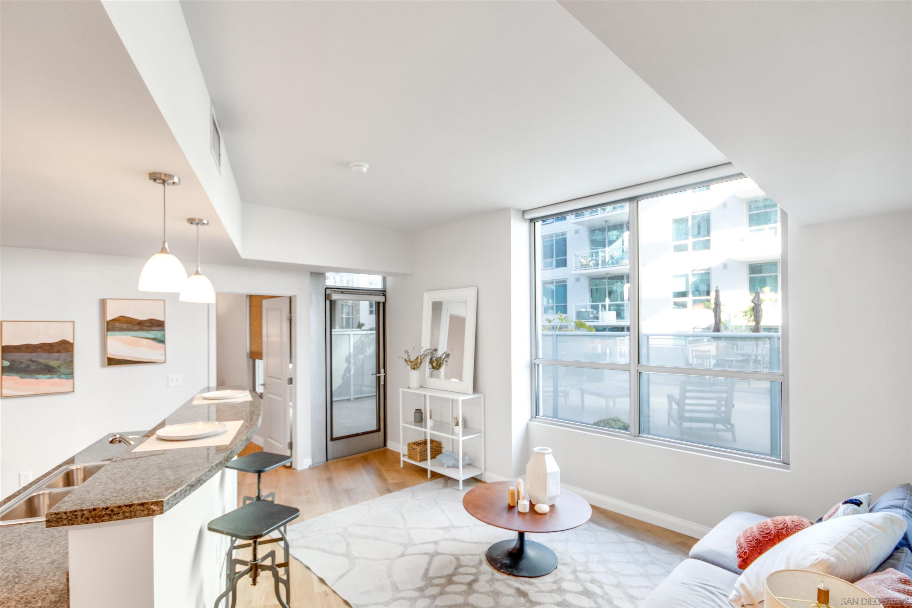 a living room with furniture and floor to ceiling windows