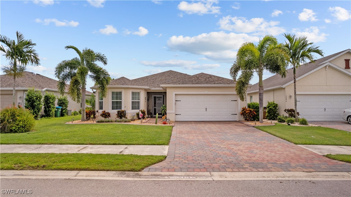 a front view of a house with a garden and yard