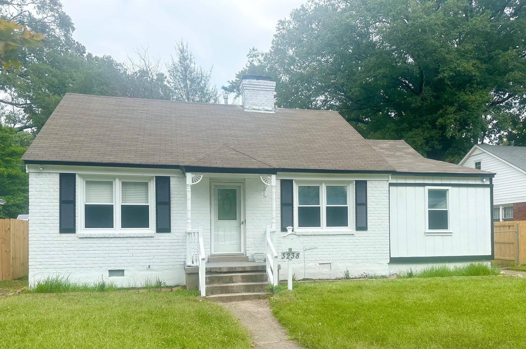 View of front of property with a front lawn