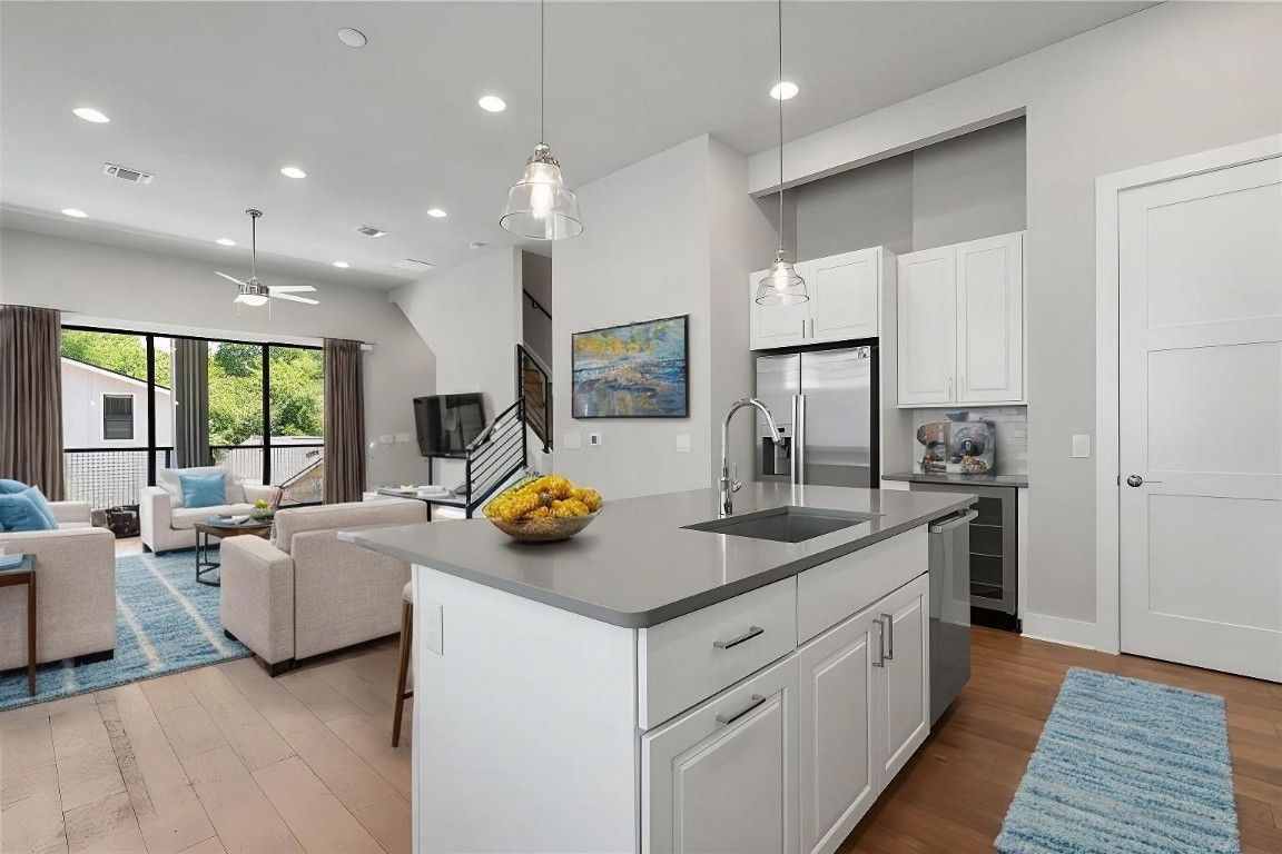 a kitchen with white cabinets and stainless steel appliances