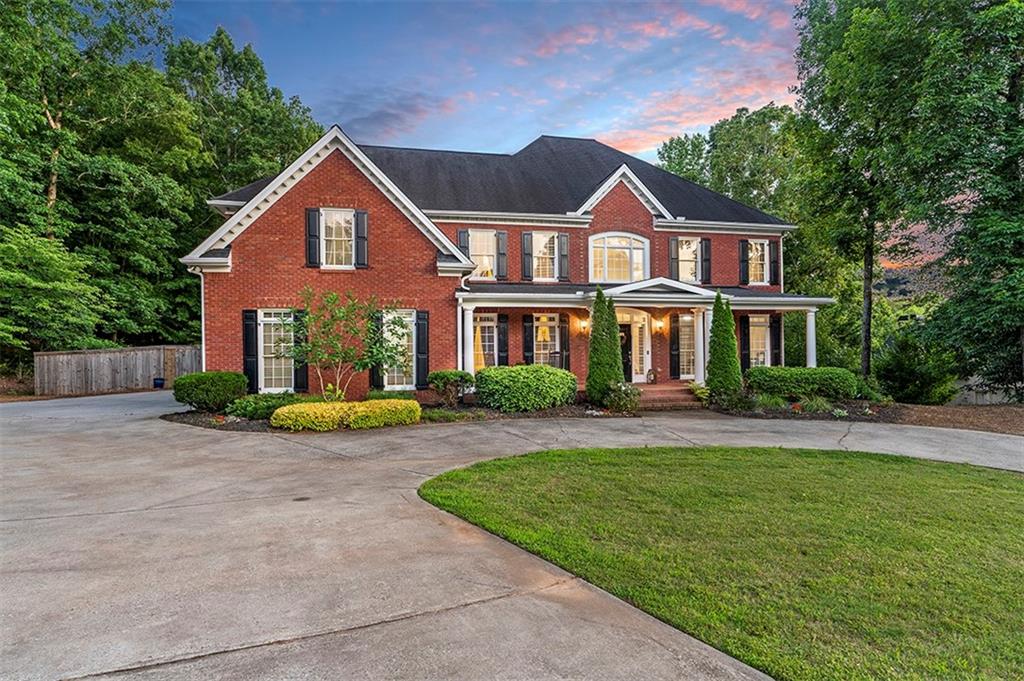 a front view of a house with a yard and porch