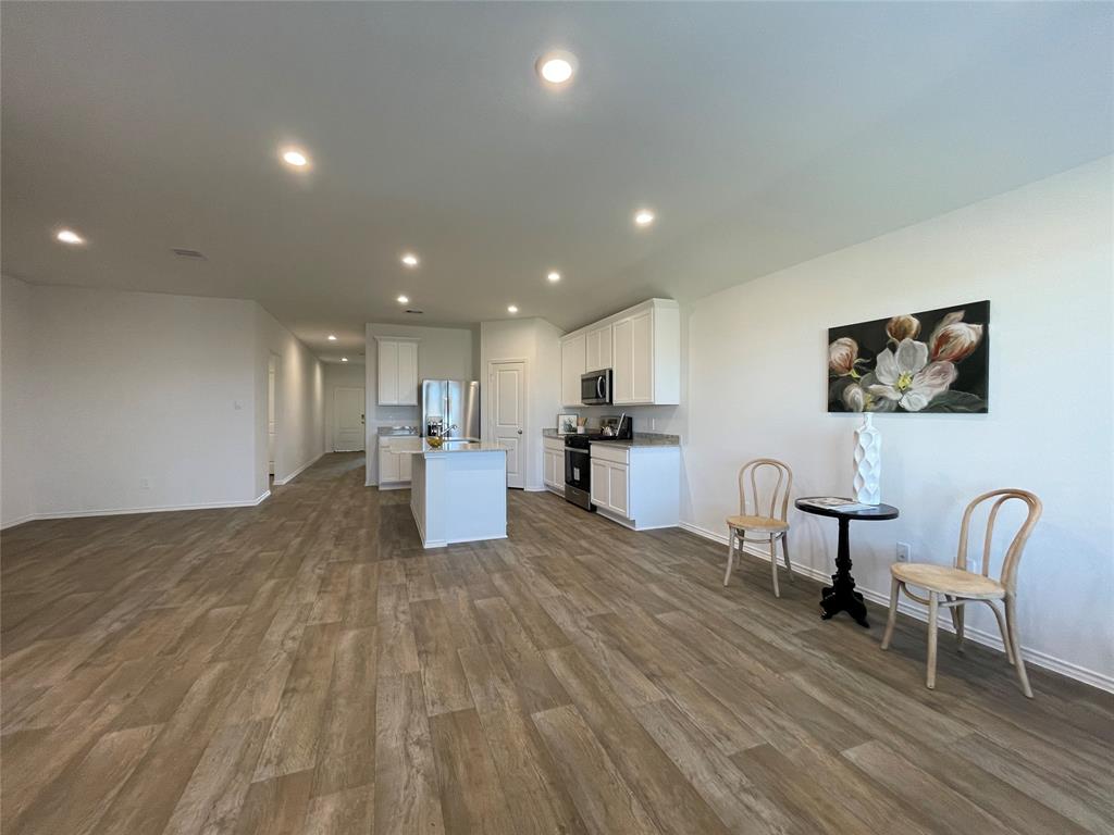 a view of kitchen with cabinets and wooden floor