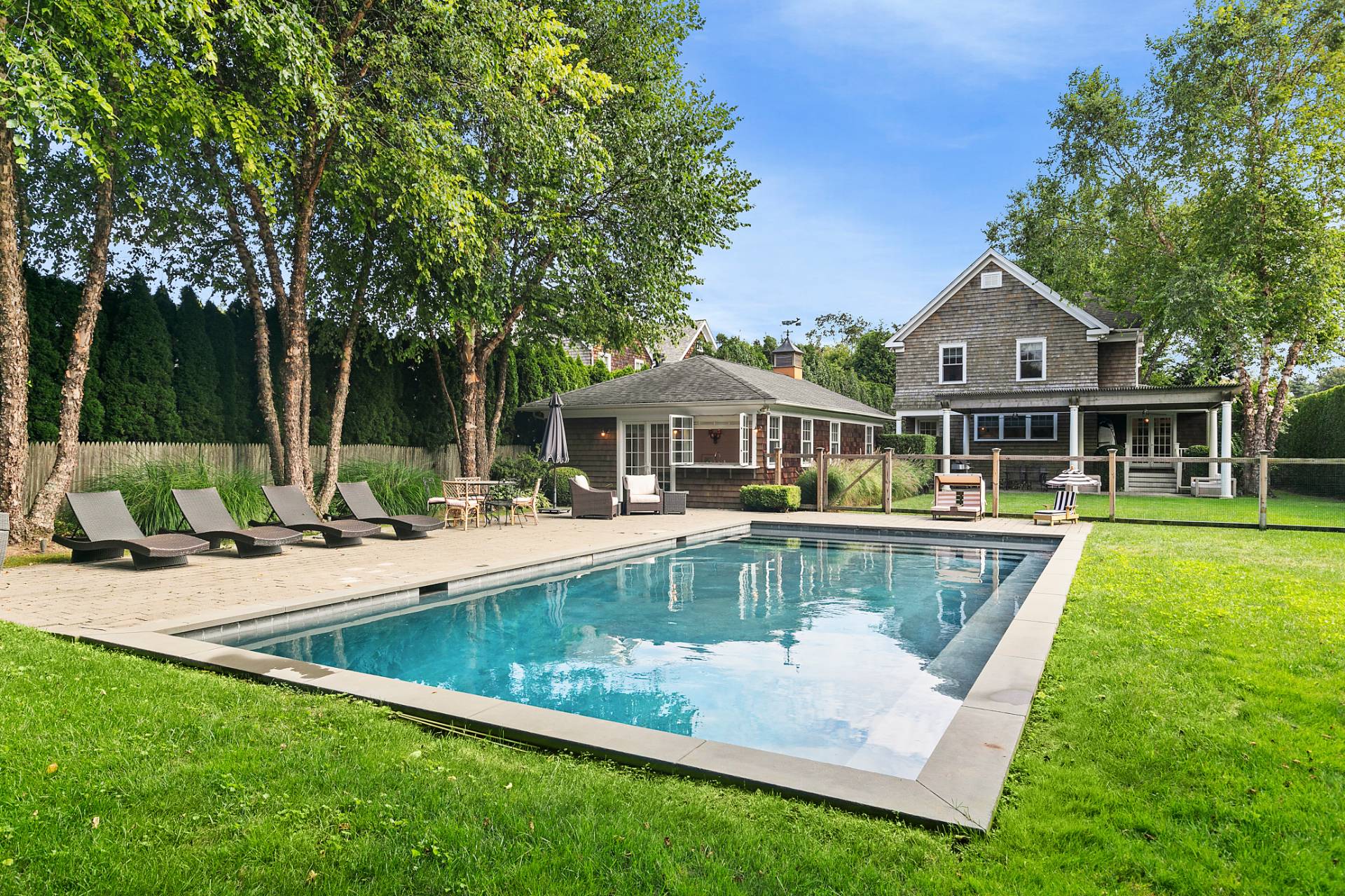 a view of a house with swimming pool and a yard