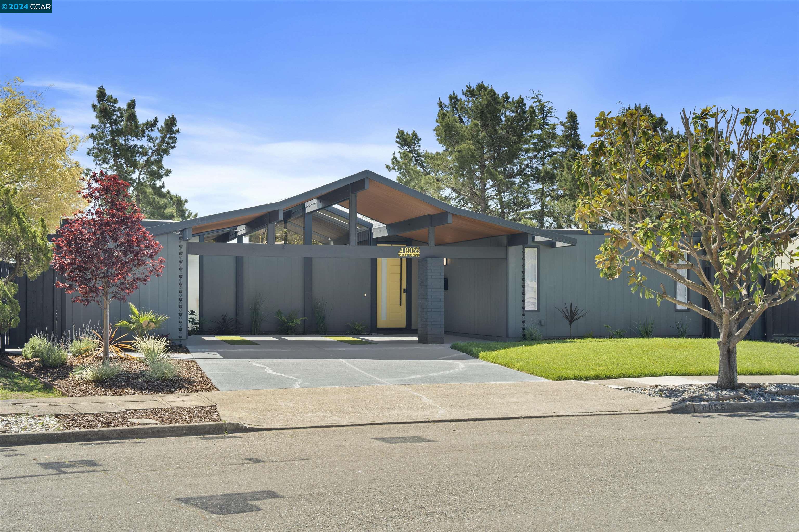 a front view of a house with a yard and a garage