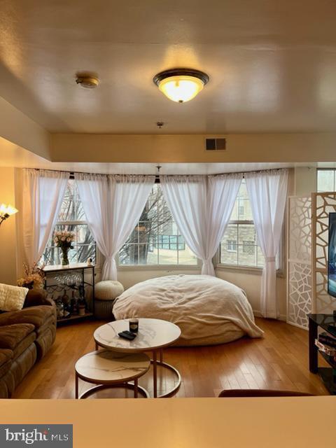 a bedroom with furniture and a large window