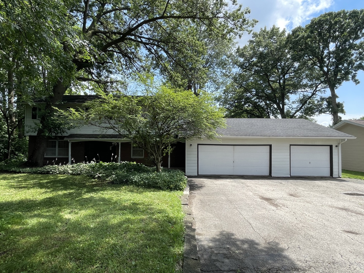 a front view of house with yard and trees