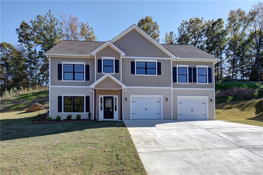 a front view of a house with a yard and garage