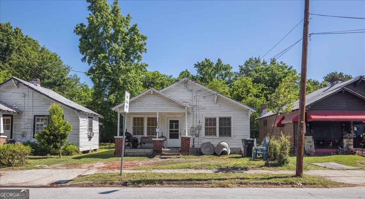 a front view of a house with garden and porch