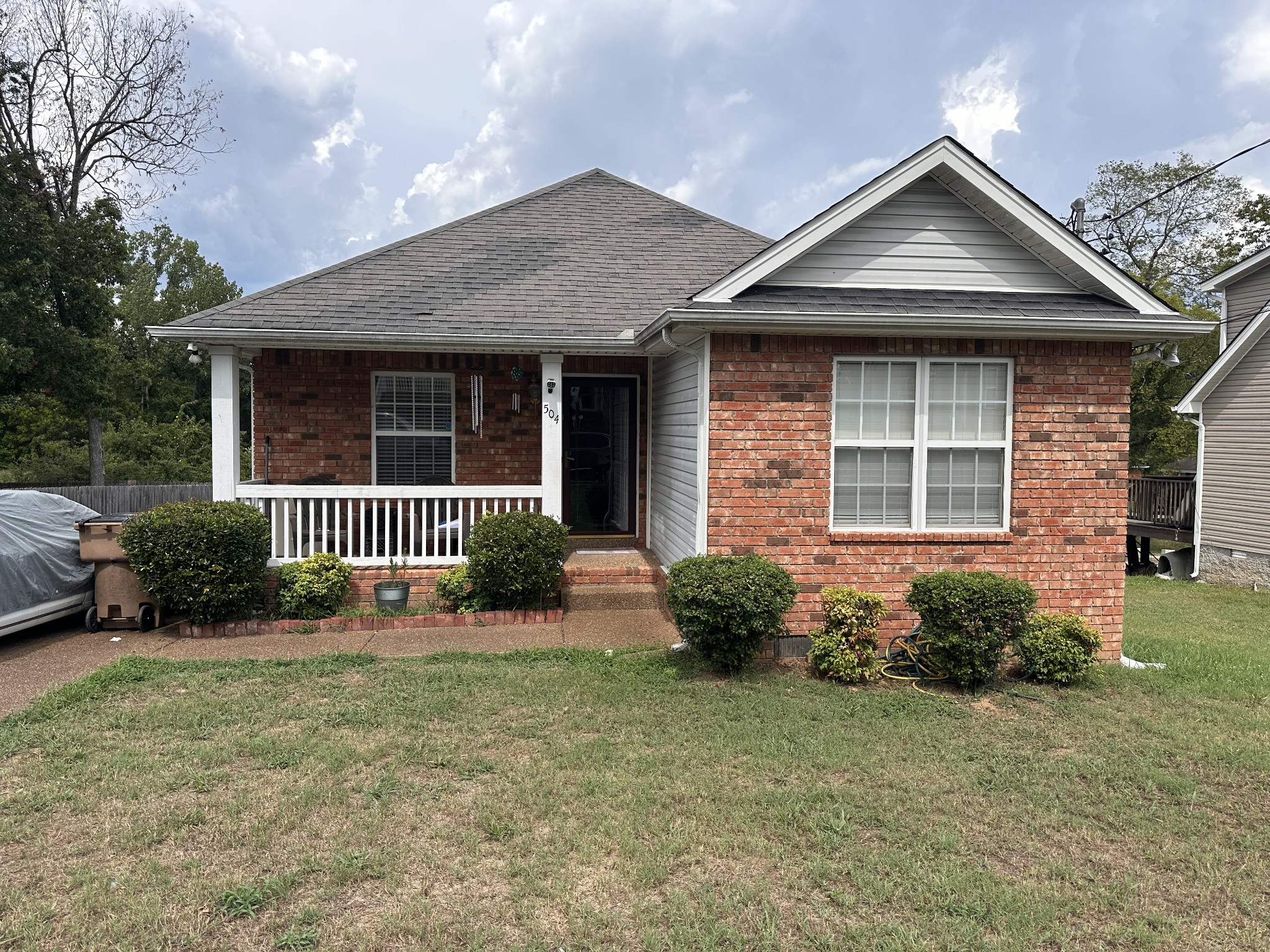 a front view of a house with a garden