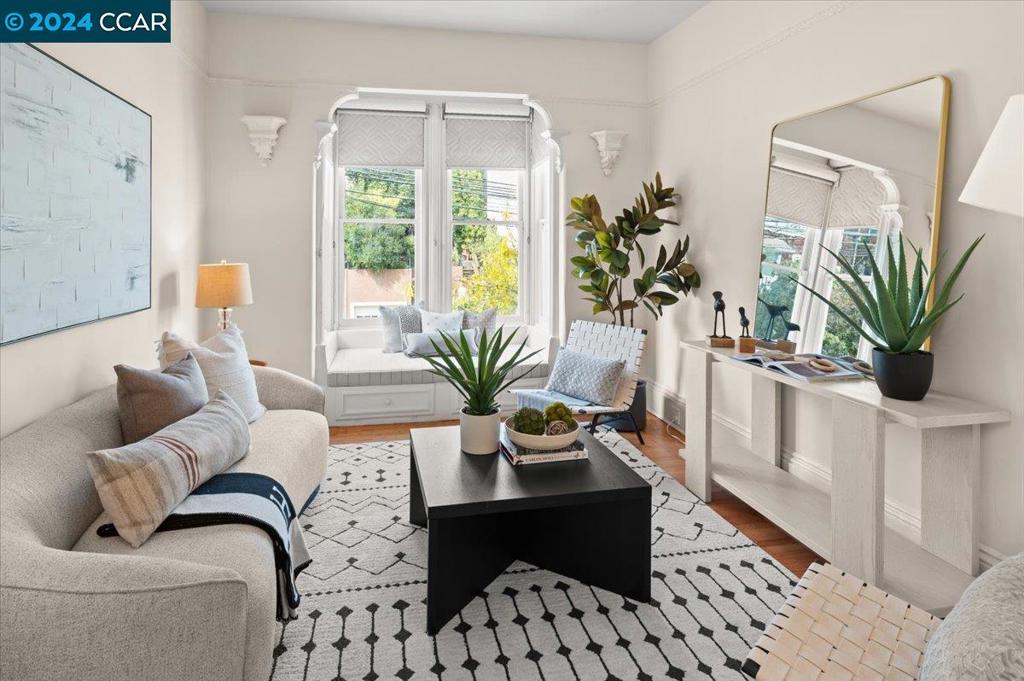 a living room with furniture potted plant and a window