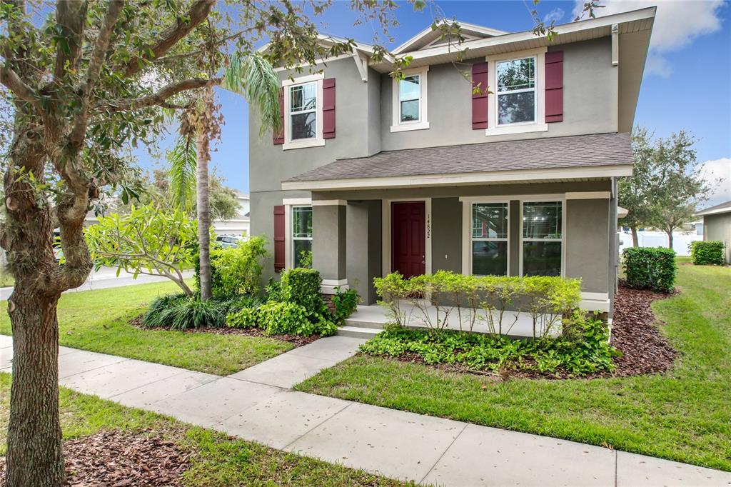 a view of a house with a yard and plants