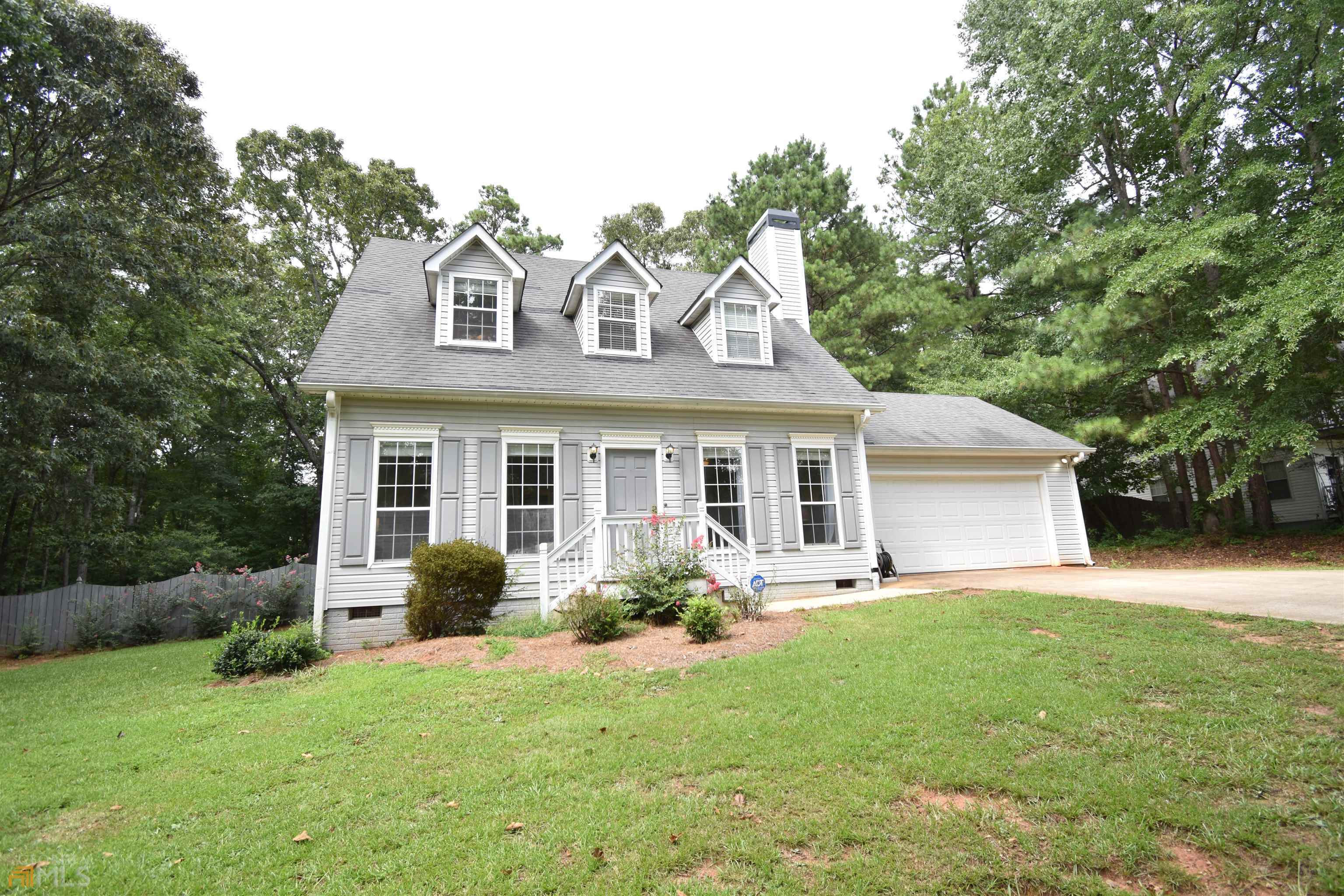 a front view of house with yard and green space