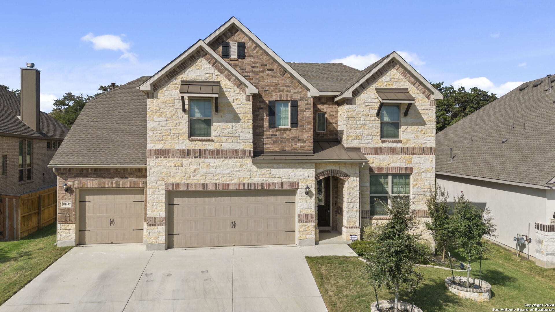 a front view of a house with a yard and garage