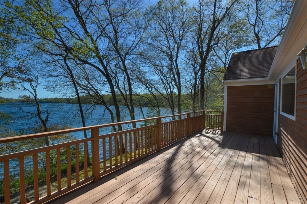 a view of balcony with wooden floor and fence