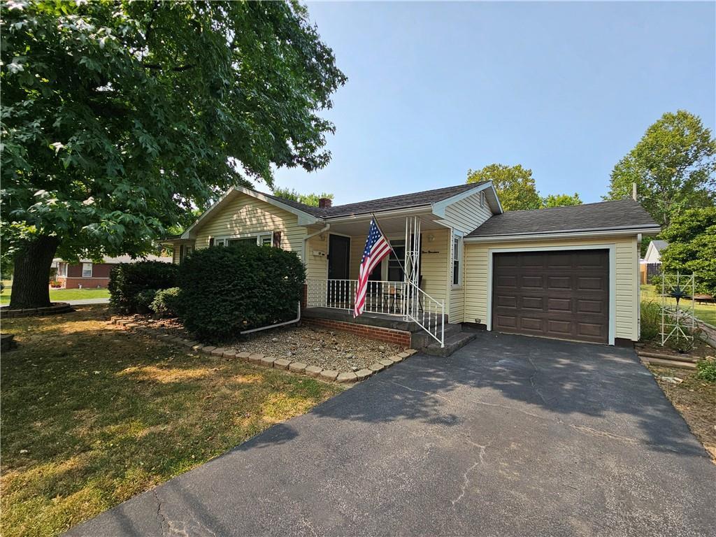 a view of a house with a yard and garage