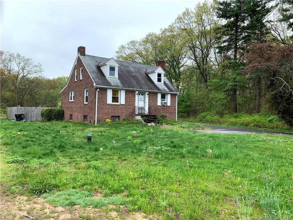 a front view of house with yard and green space