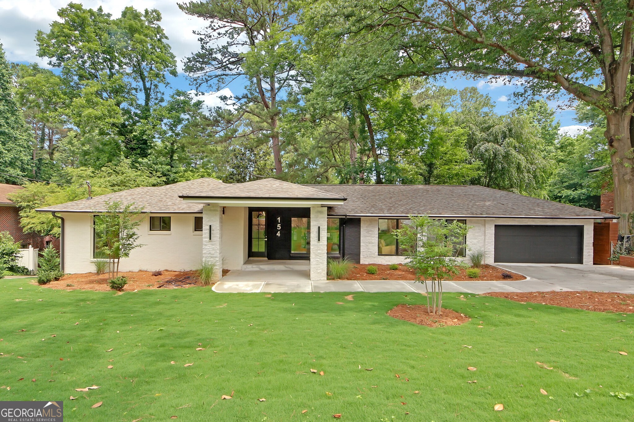 a front view of a house with a yard garden