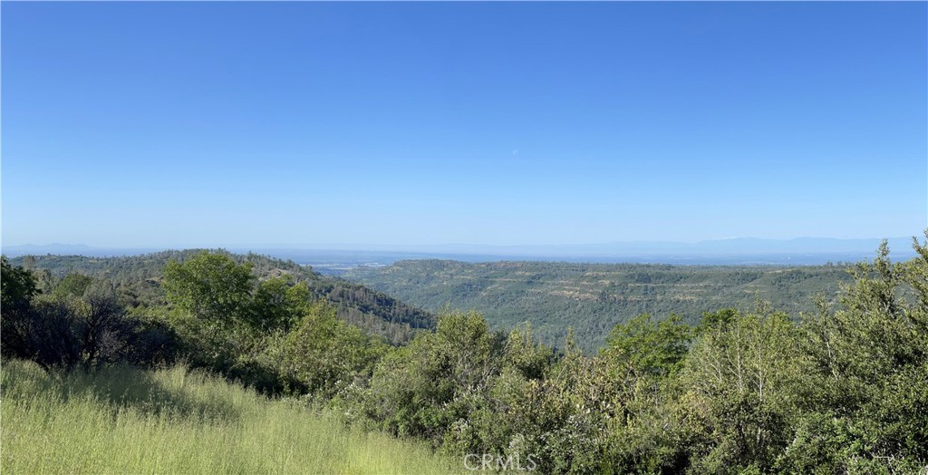 a view of a lake and green valley