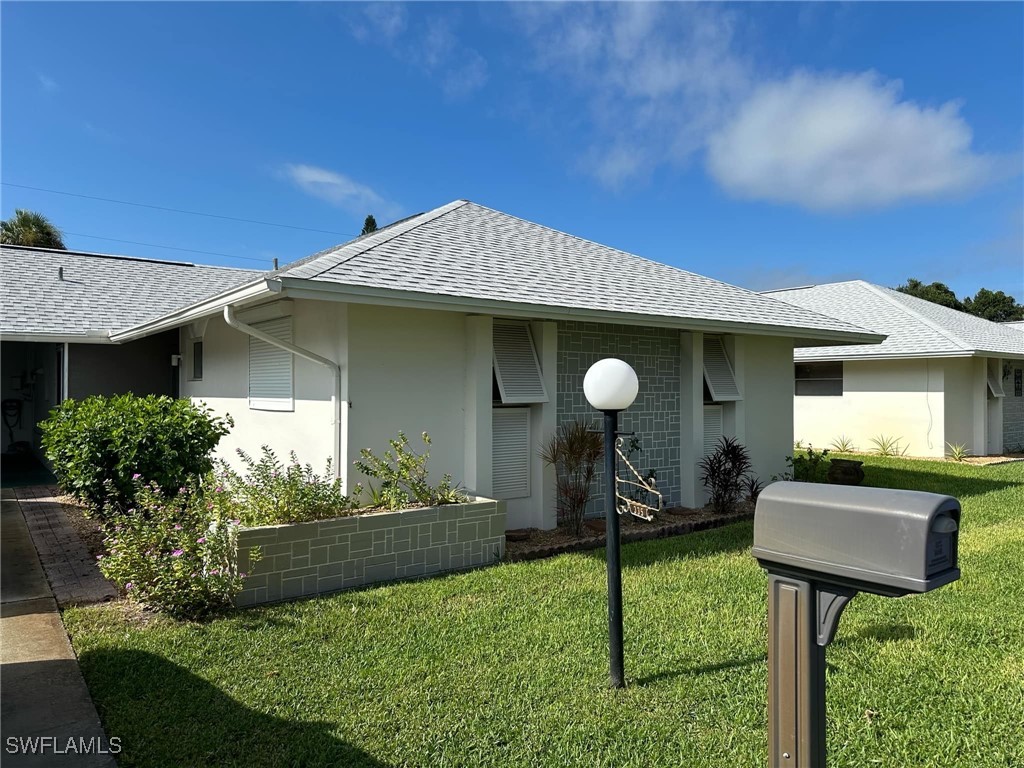 a view of a house with backyard porch and furniture