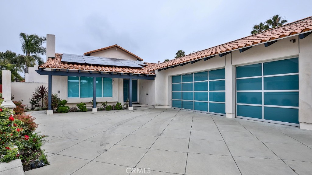 a view of a house with a patio and a yard