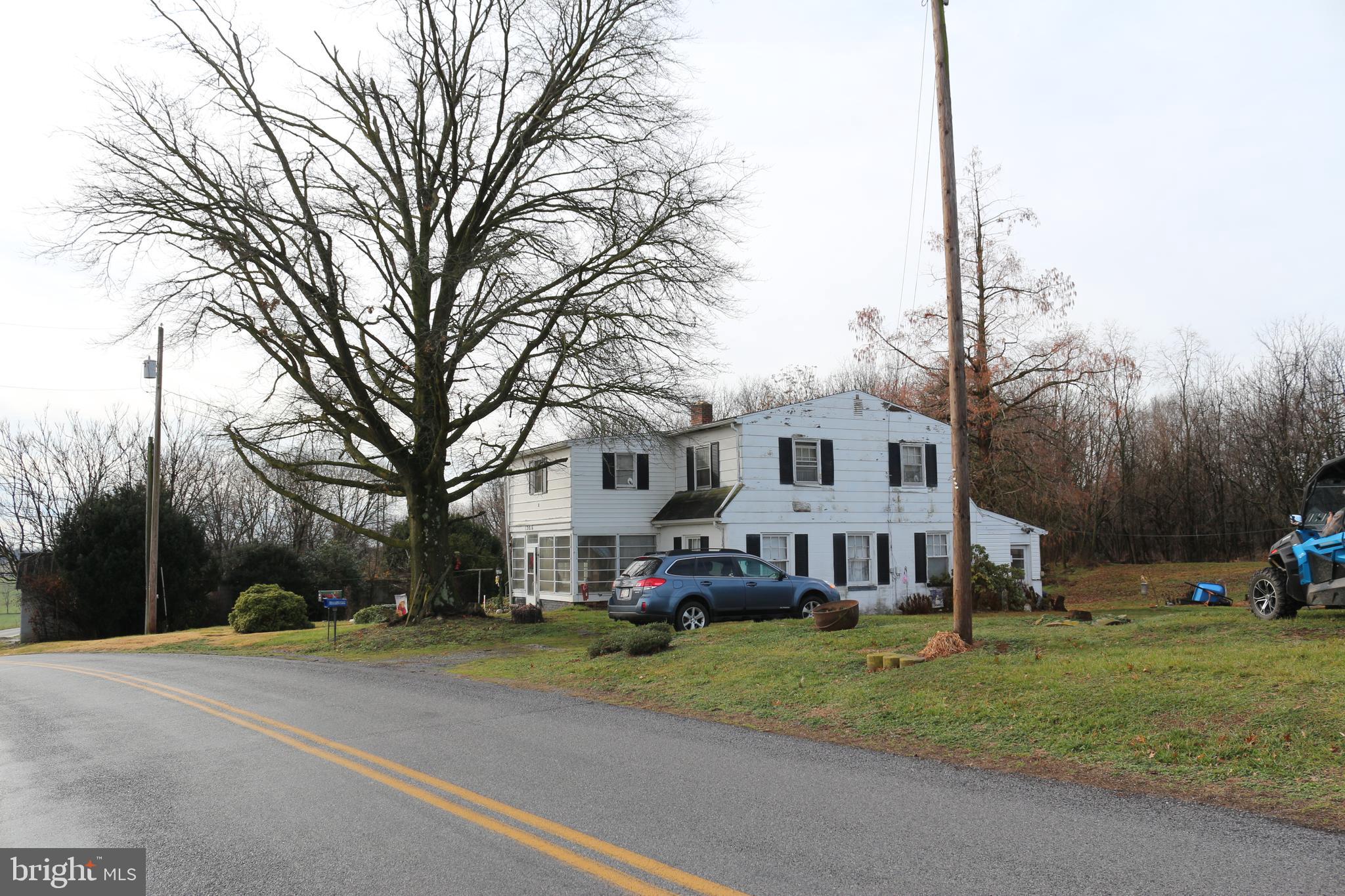 a view of a house with a big yard next to a road