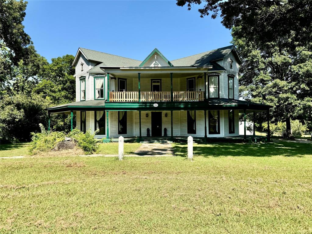 a front view of a house with a yard table and chairs