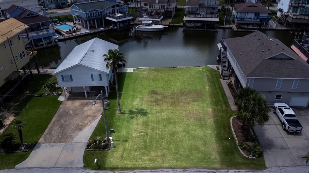 an aerial view of a house with garden space and a car park