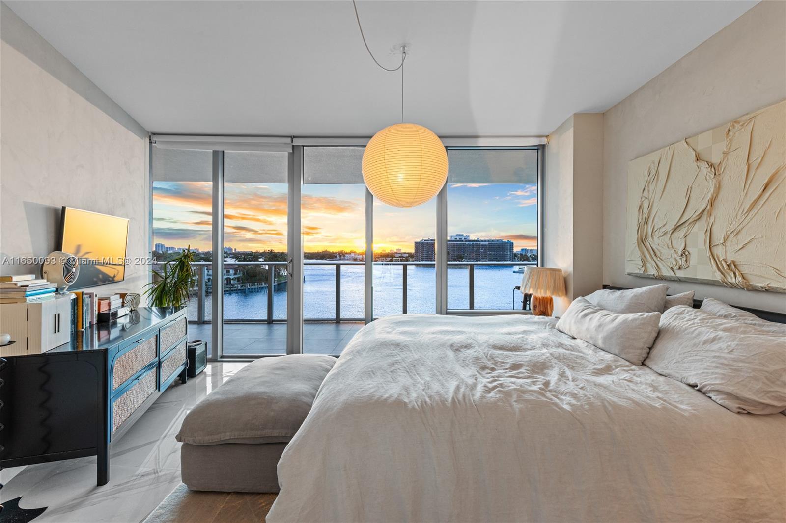 a bedroom with a large bed and a large window