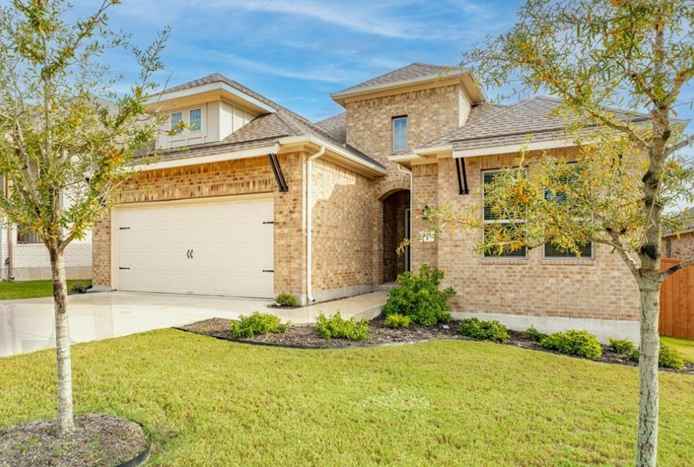 a front view of a house with a yard