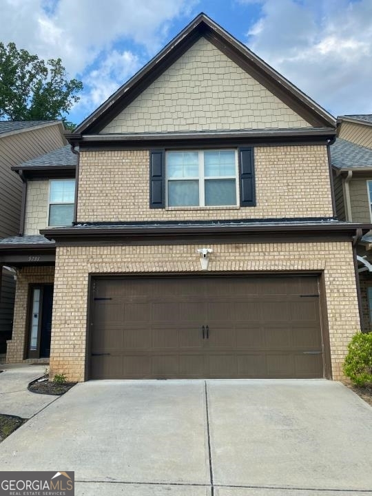 a front view of a house with garage