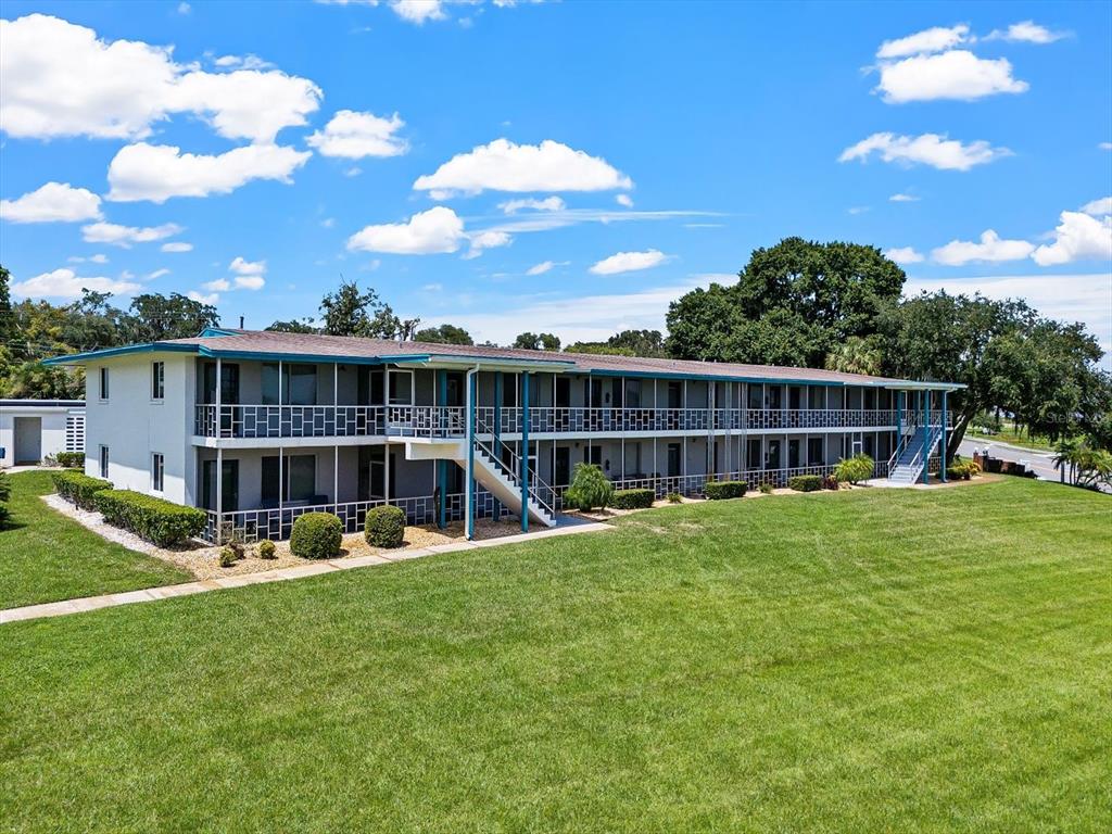 a view of an house with backyard space and balcony