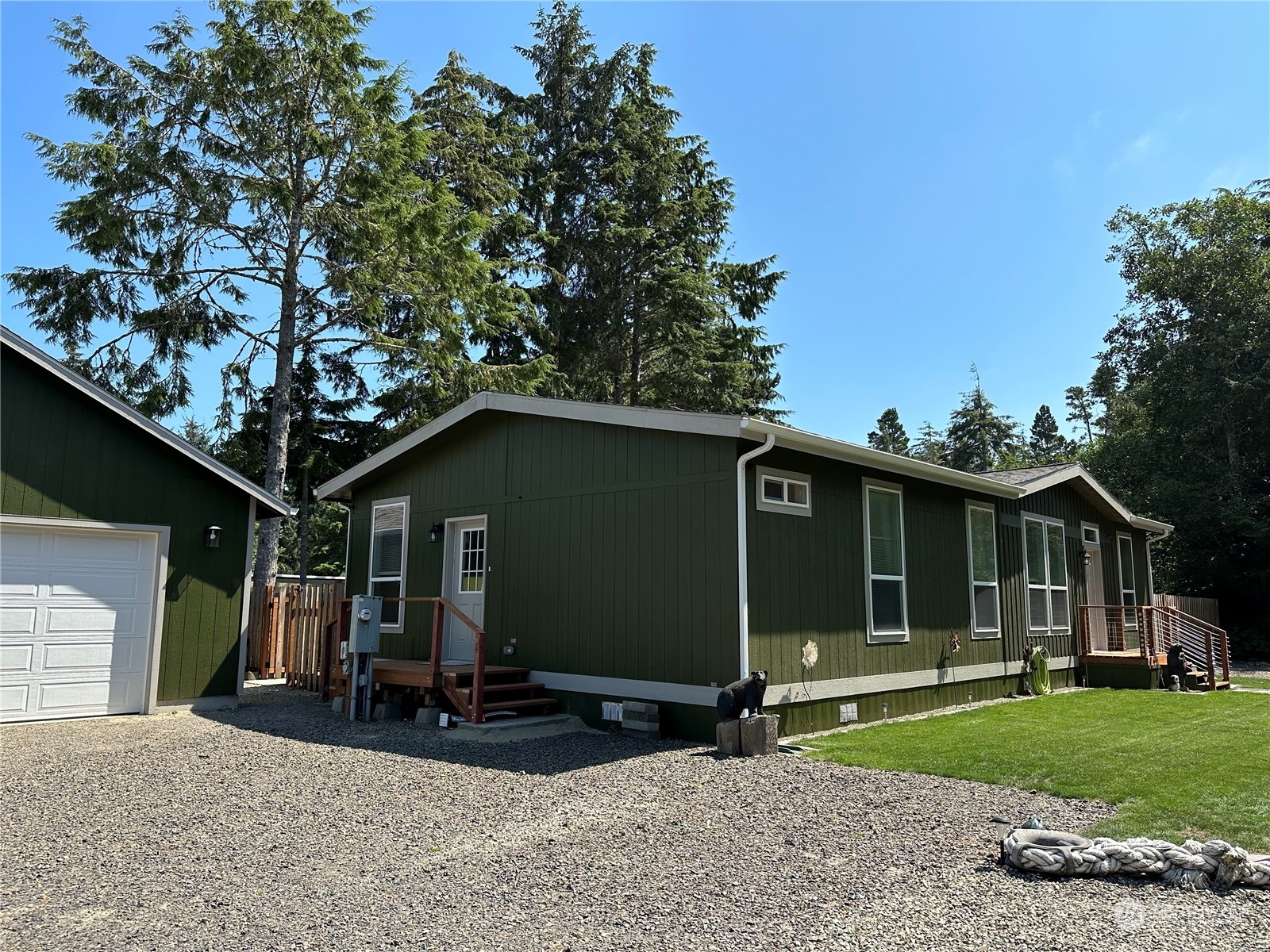 a view of a house with a patio and a yard