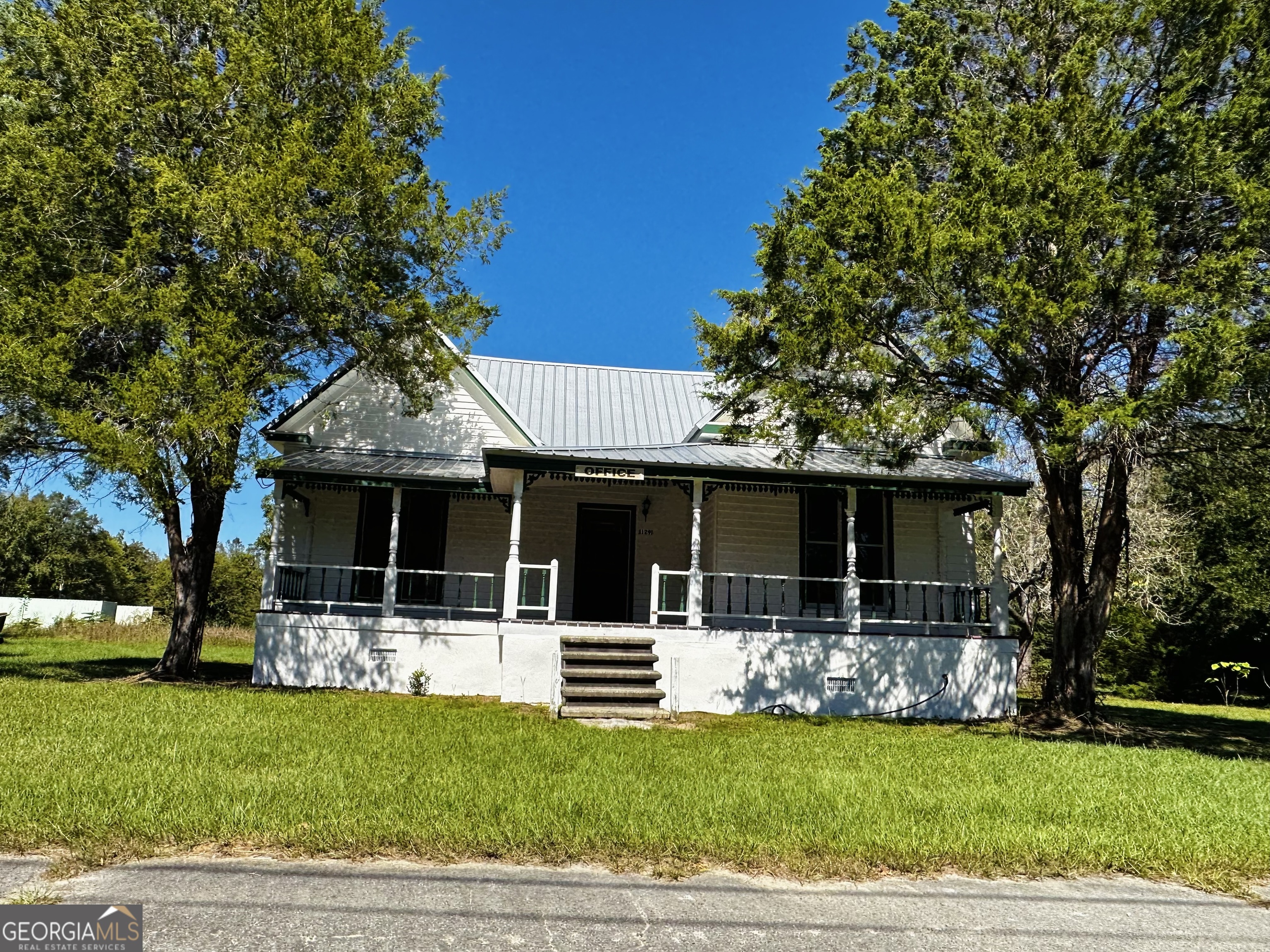 a front view of a house with a garden