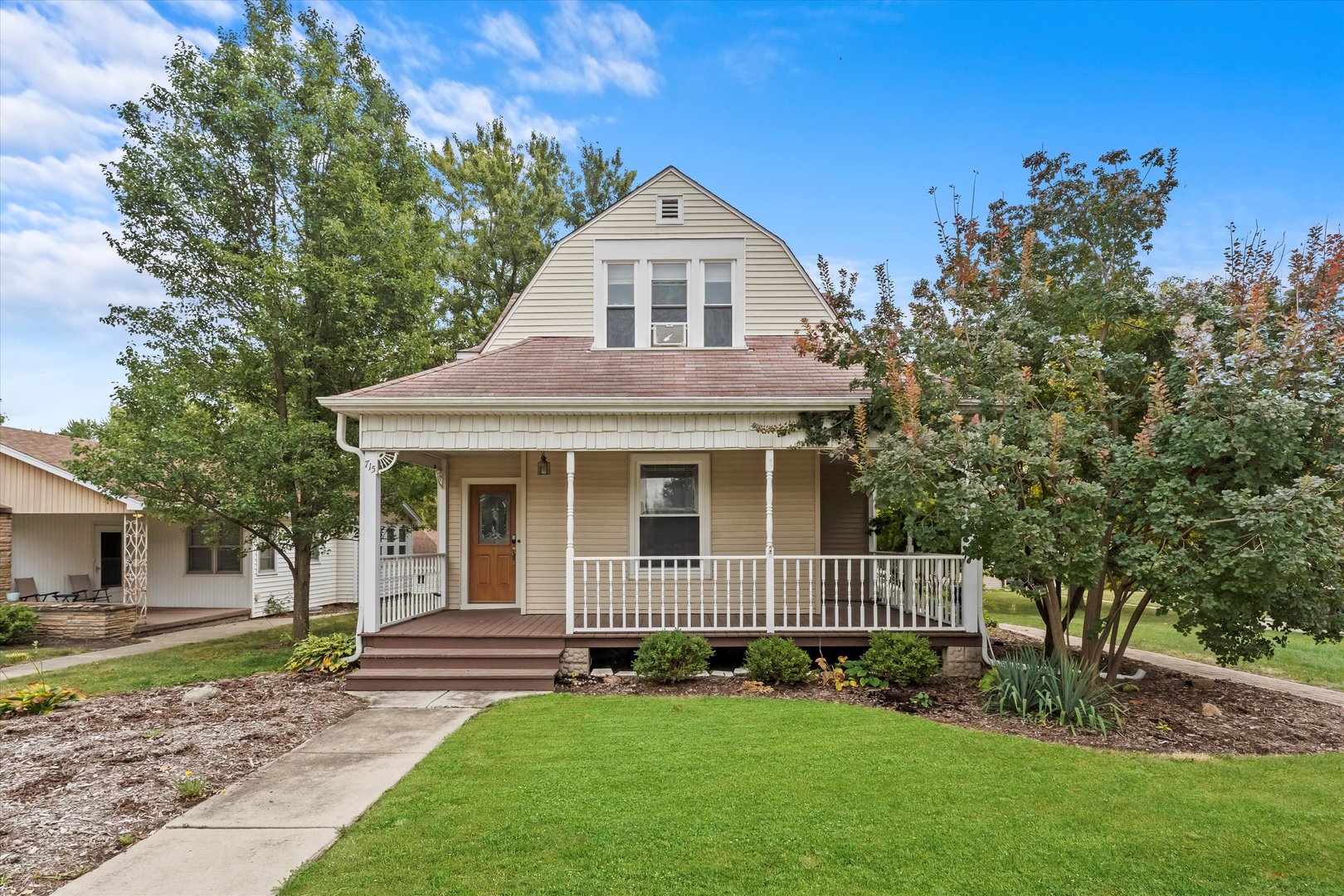 a front view of a house with a garden