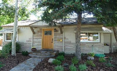 a view of a small house with a tree