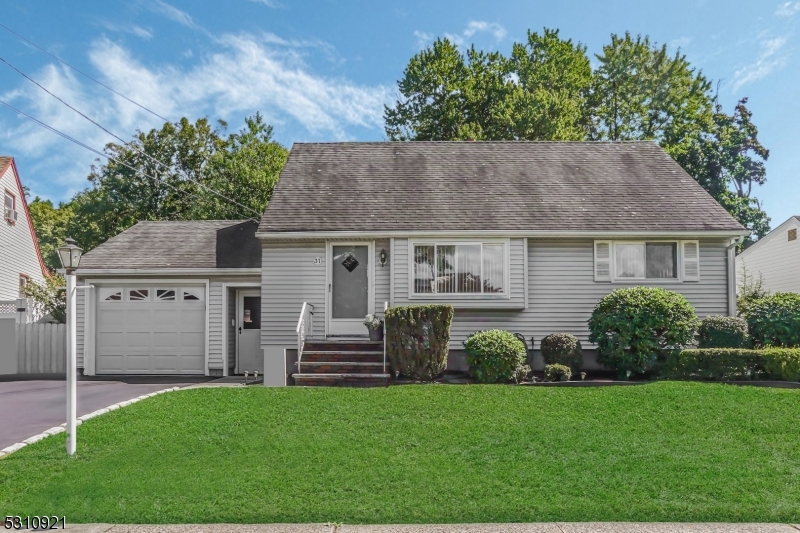 a aerial view of a house with porch and garden