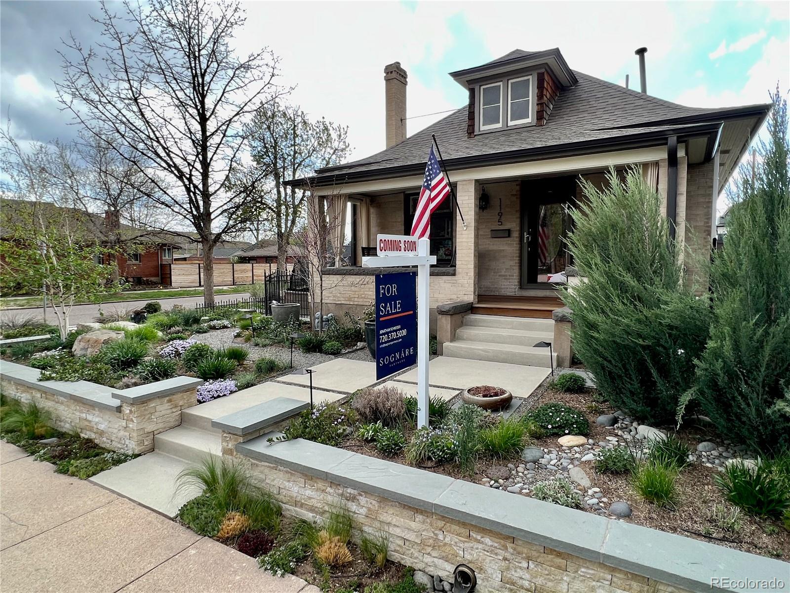 a front view of a house with garden