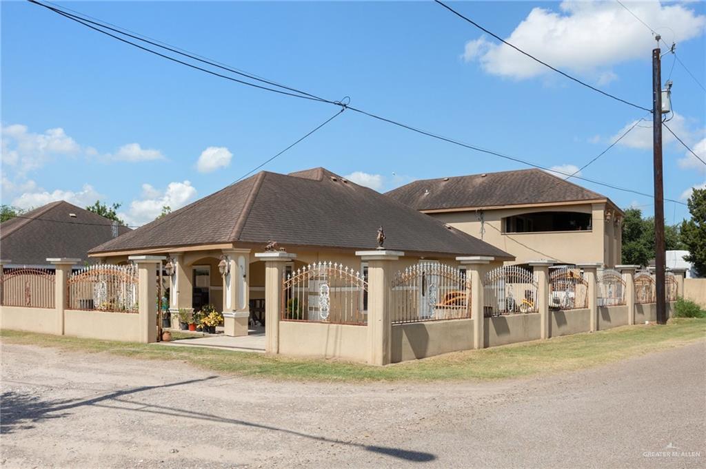 a view of a house with a patio and a yard