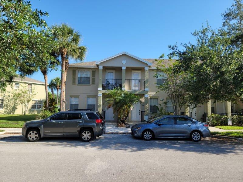 a view of cars parked in front of a house