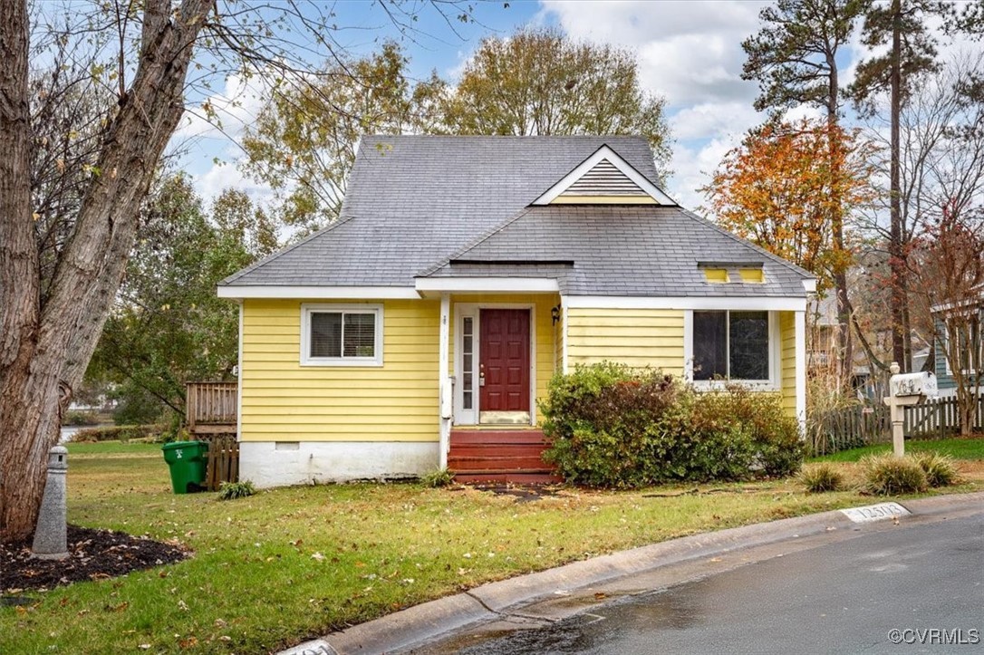 Bungalow-style home with a front lawn