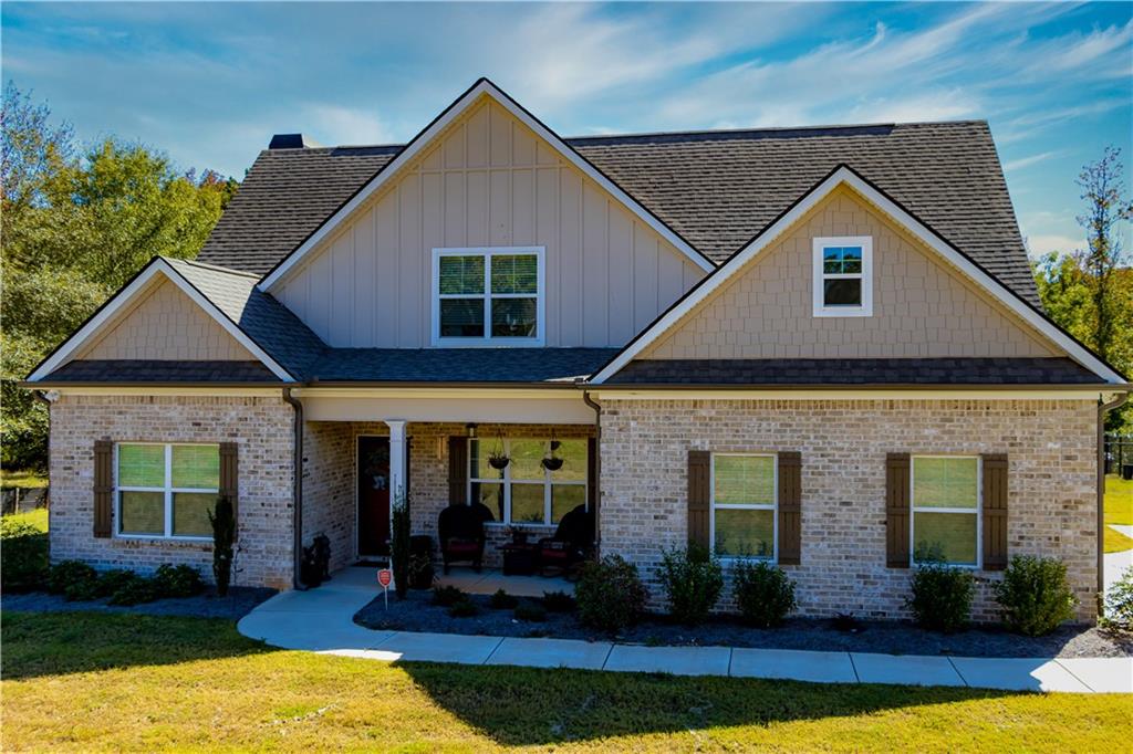 a front view of a house with yard and seating space